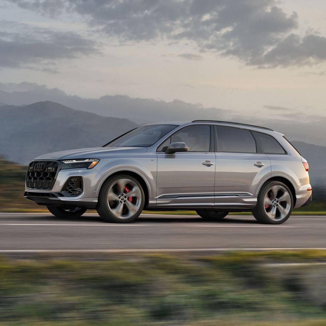 Right side profile view of an Audi Q7 accelerating.